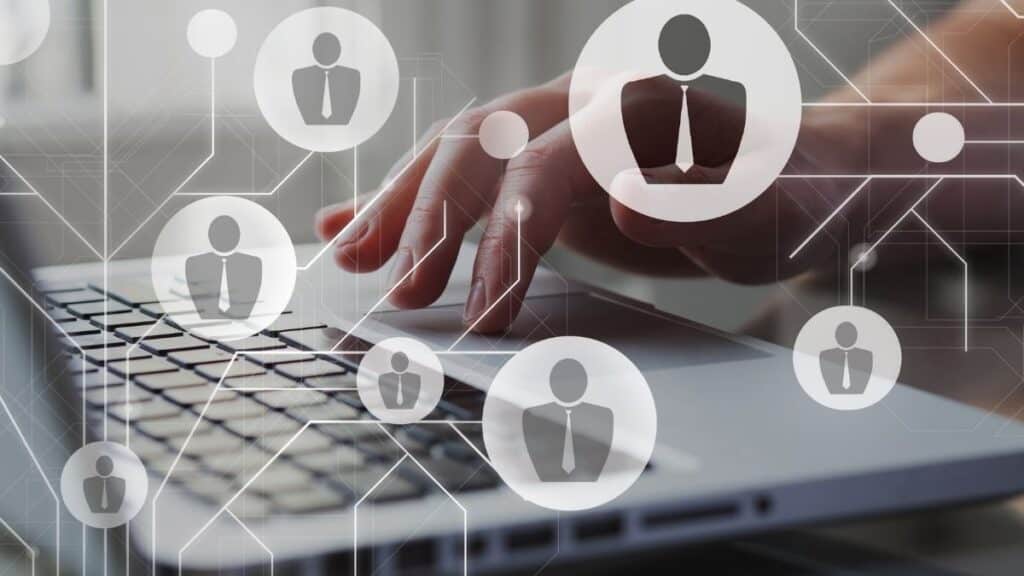 Person typing on a computer with overlayed graphic of provider network representing provider screening.