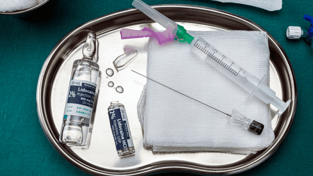 Anesthesia agents on a stainless steel surgical instrument tray representing malpractice.